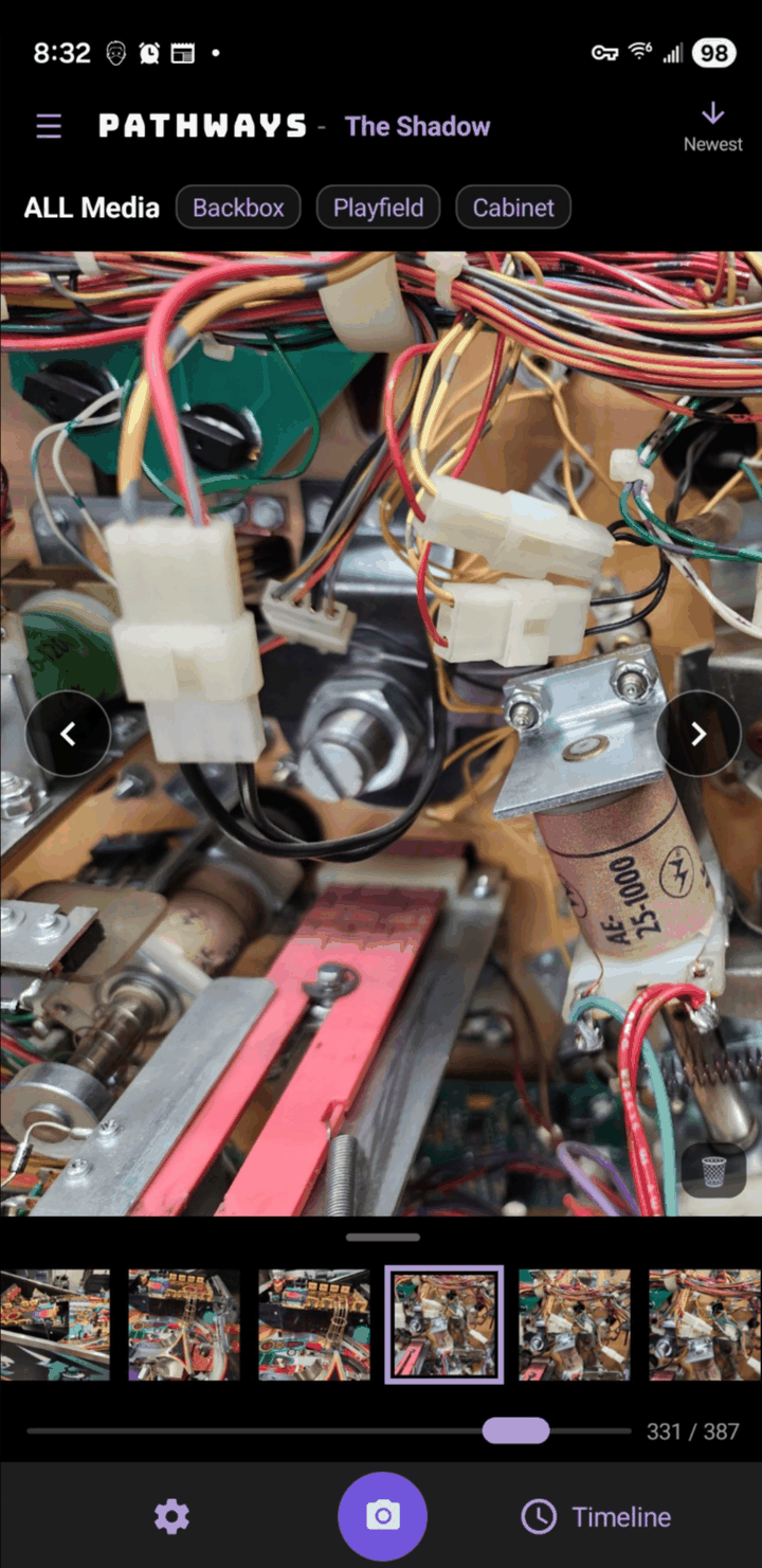 The Pathways app on a phone: a captured photo of the machine's wiring, the project's filmstrip beneath it, and the capture button at the bottom.